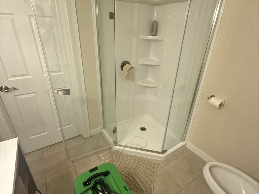 Dehumidifier and air movers running inside a contained bathroom